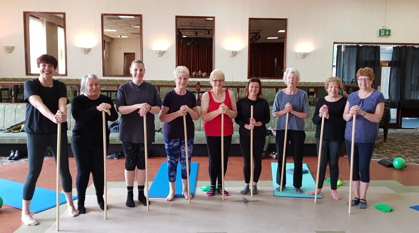 Older Start Right Pilates members using poles for supported movement